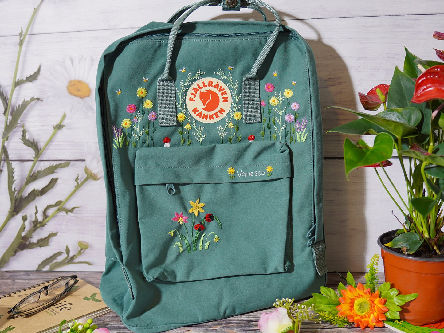 Fjallraven kanken backpack embroidered with ladybugs and colorful flowers, Ladybug embroidery design on Fjallraven Kanken backpack