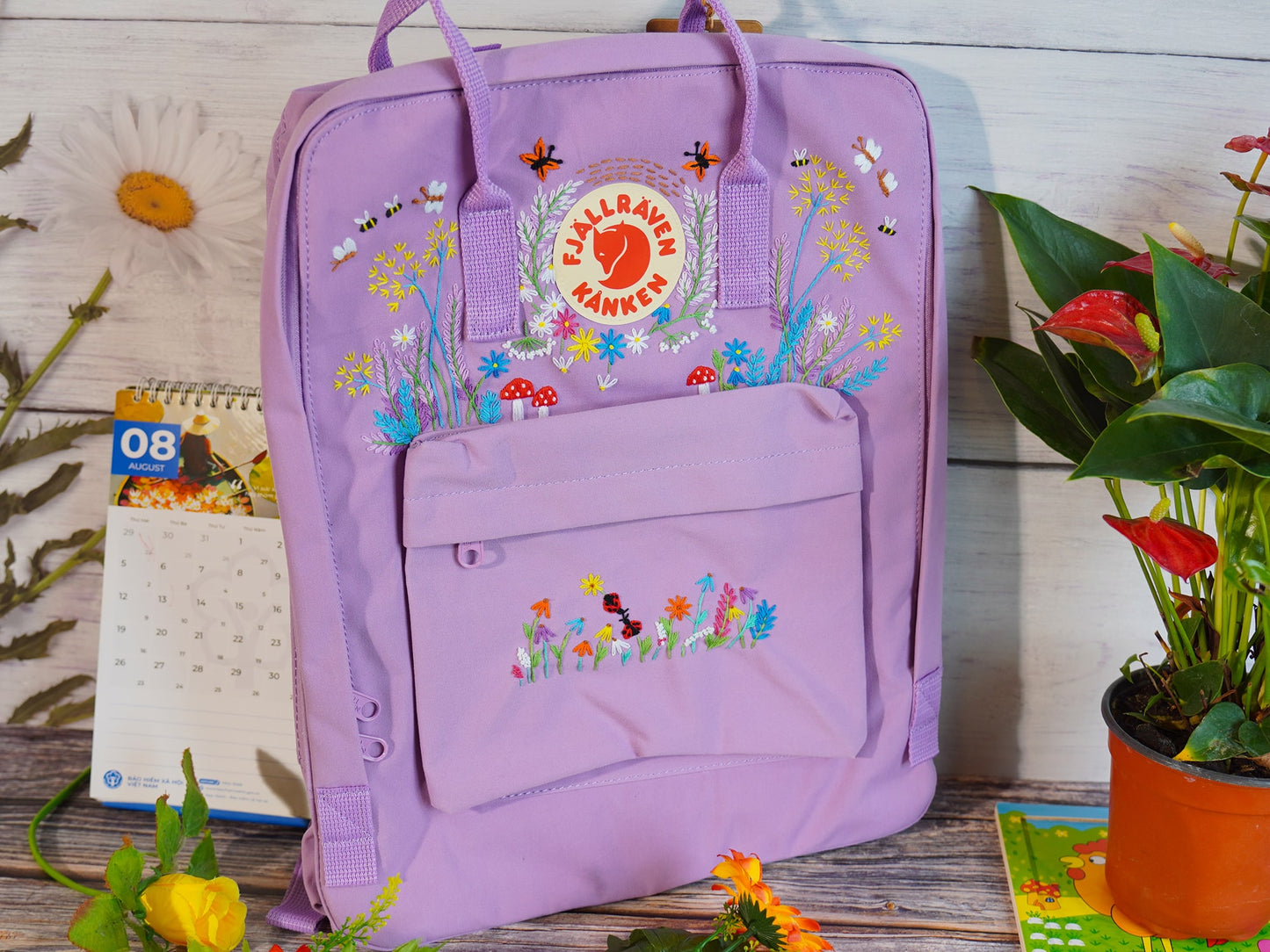 Floral and butterfly embroidery design on fjallraven kanken backpack