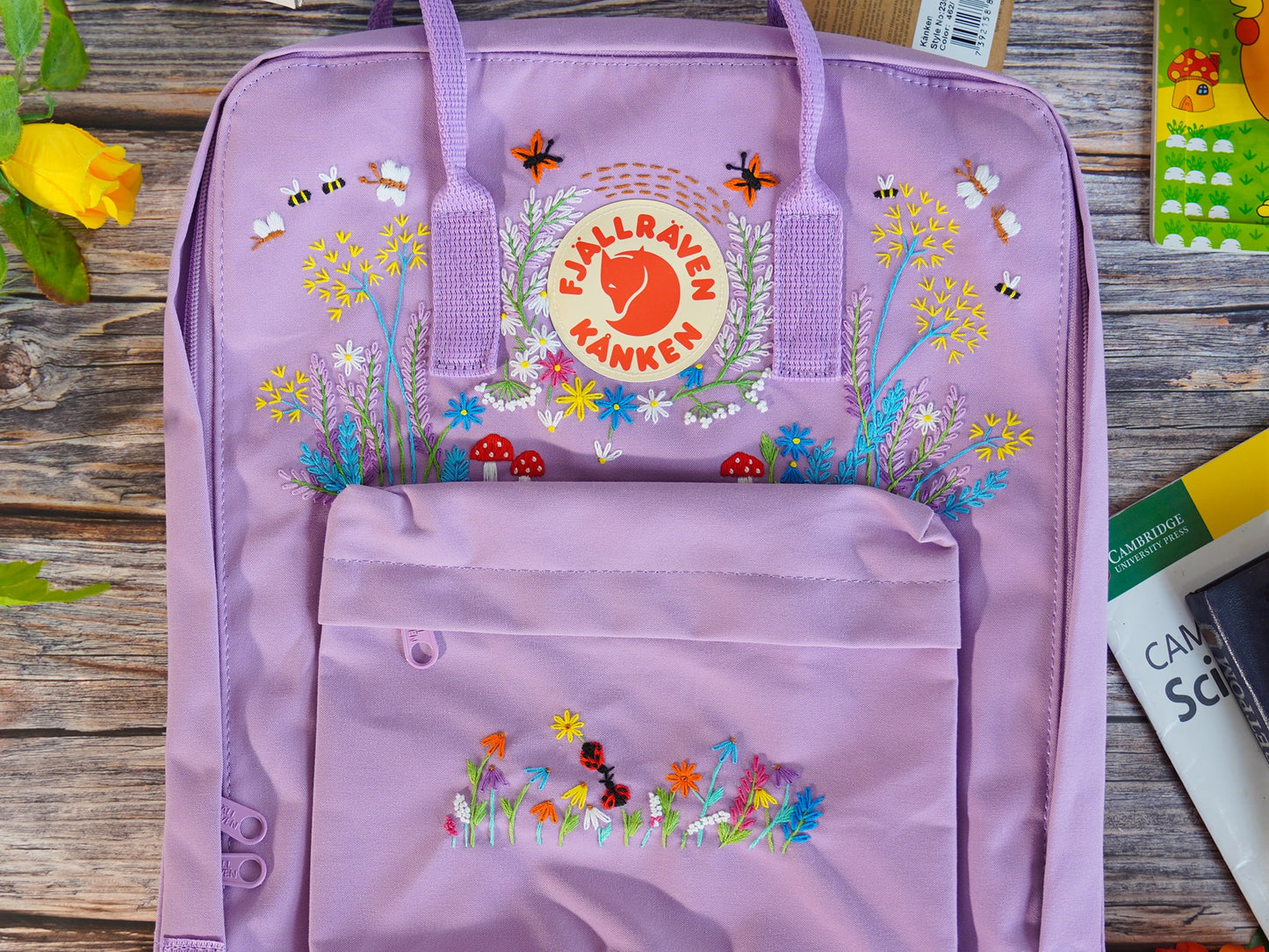 Floral and butterfly embroidery design on fjallraven kanken backpack