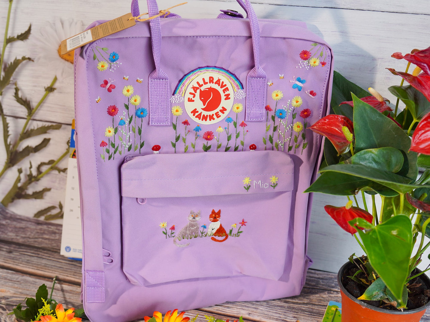 Hand embroidered fjallraven kanken backpack with rainbow flower and cat design