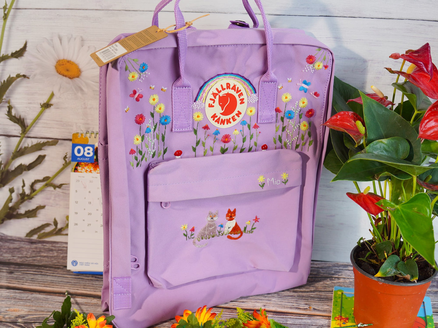 Hand embroidered fjallraven kanken backpack with rainbow flower and cat design