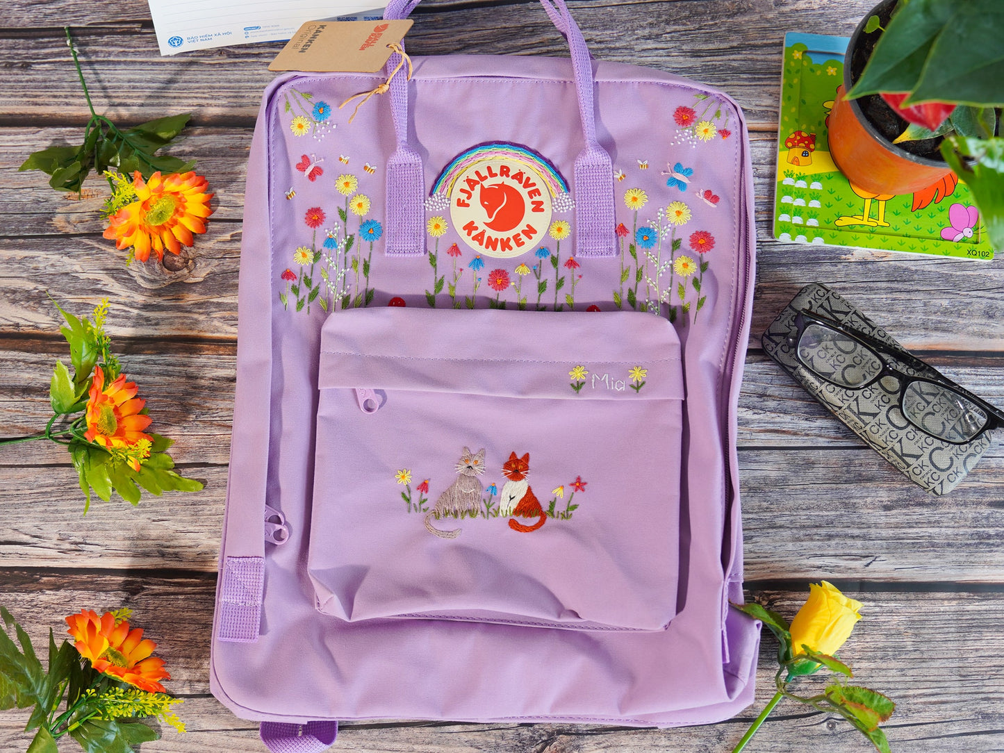 Hand embroidered fjallraven kanken backpack with rainbow flower and cat design